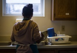 In the lower level of Avondale United Methodist Church, off of 10th and Sampson St in Muncie, Ind., Ball State Urban Planning Graduate Student Varu Musumuri, washes dishes while her classmates and other volunteers prepare the weekly Thursday night commune dinner for the community. Grace Hollars, NPPA