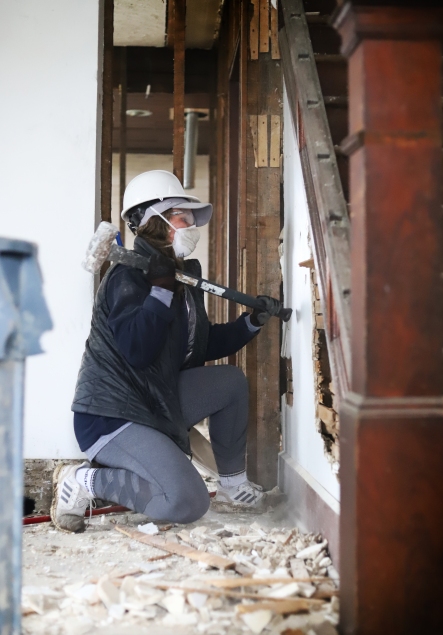 Ball State student, Alli McCrady sledgehammering a wall under the staircase for Habitat for Humanity on Saturday Aril 9th in Muncie IN. Madison Del Valle